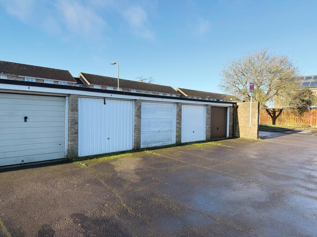 Lot: 29 - THREE FREEHOLD GARAGES WHICH FORM PART OF A LARGER BLOCK - View of garages with up-and-over doors